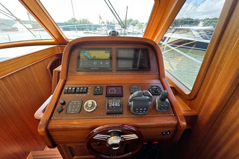  Yacht Photos Pics Cockpit of 2020 Vicem 50 Classic yacht with wooden dashboard and navigation controls.
