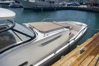 2021 Nimbus T11 boat docked at marina, featuring sleek design and spacious deck.