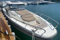 2021 Nimbus T11 motorboat docked at marina, featuring sleek design and spacious deck.