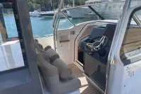 Interior view of 2021 Nimbus T11 boat with steering wheel and seating.