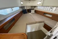 Luxurious interior cabin of 2021 Nimbus T11 boat with cozy bedding and cushions.
