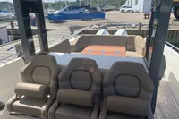 Interior view of 2021 Nimbus T11 boat with comfortable seating and dockside background.