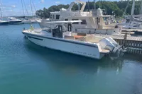 Nimbus T11 2021 boat docked in a marina, surrounded by other vessels.