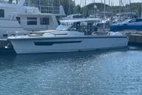 2021 Nimbus T11 boat docked at a marina, surrounded by other vessels.