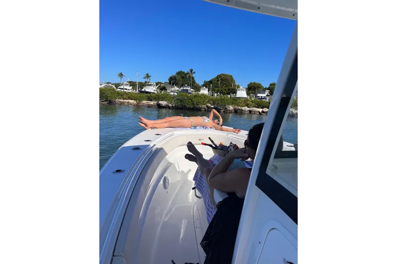  Yacht Photos Pics 2021 Sea Hunt Gamefish 30 Coffin Box with people relaxing on deck in sunny waters.