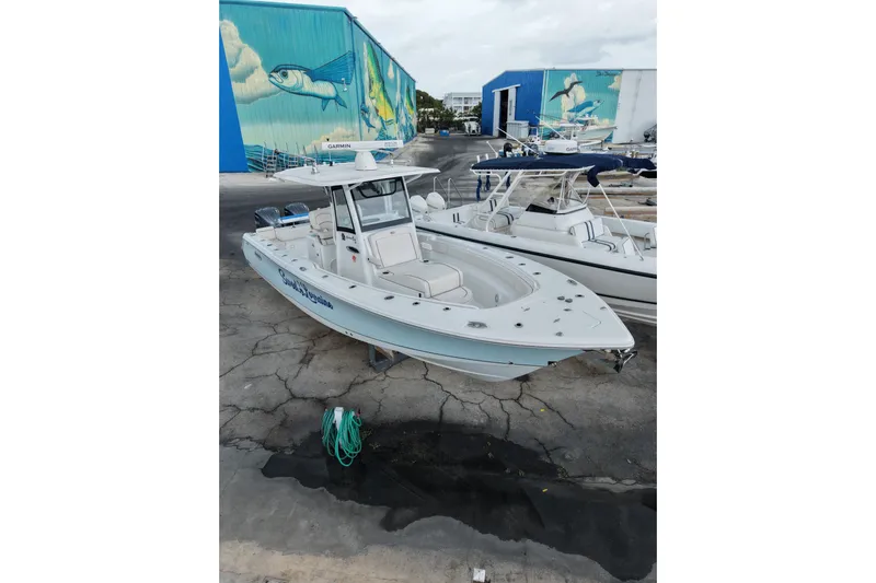  Yacht Photos Pics 2021 Sea Hunt Gamefish 30 Coffin Box boat docked, with vibrant marine mural background.