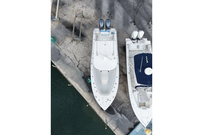  Yacht Photos Pics Aerial view of 2021 Sea Hunt Gamefish 30 Coffin Box docked beside another boat.