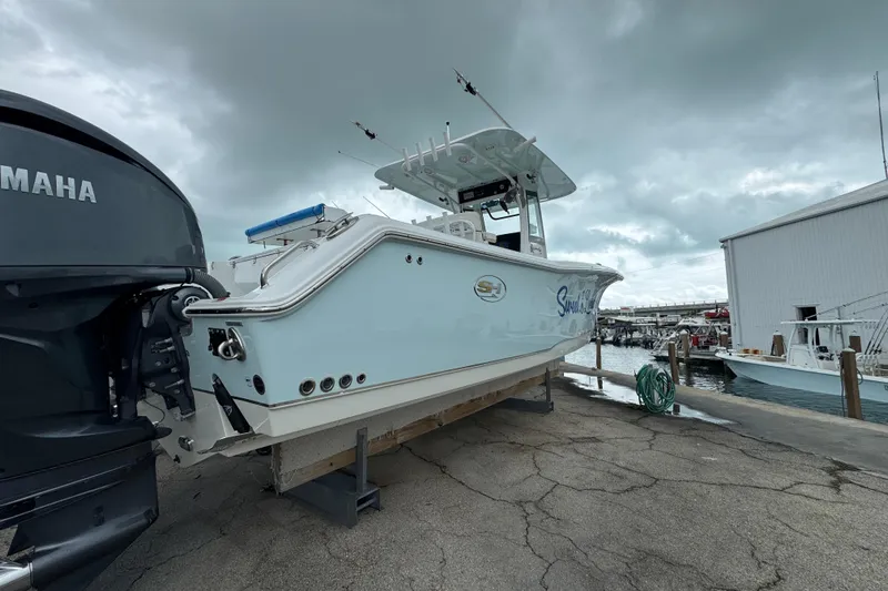  Yacht Photos Pics 2021 Sea Hunt Gamefish 30 Coffin Box boat docked with Yamaha engine, cloudy sky.
