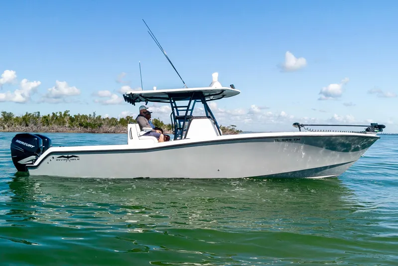  Yacht Photos Pics 2022 Invincible 33 Open Fisherman boat on calm water, side view.