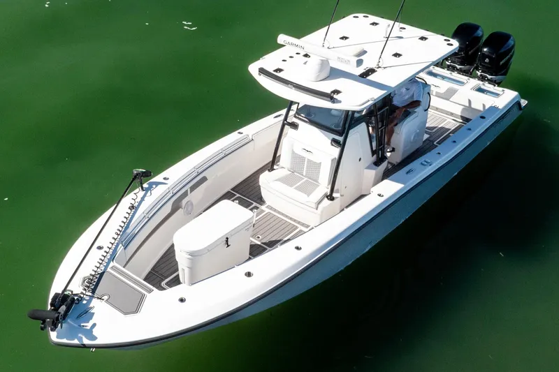  Yacht Photos Pics 2022 Invincible 33 Open Fisherman boat on calm green water.