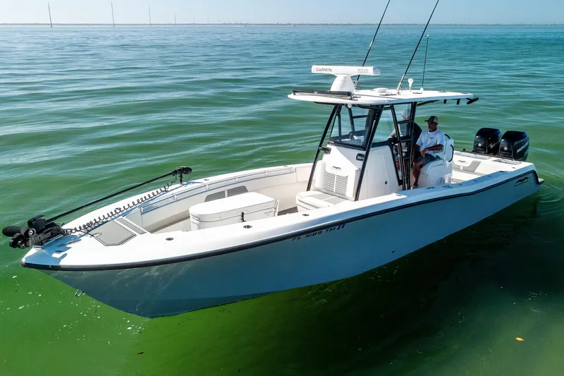  Yacht Photos Pics 2022 Invincible 33 Open Fisherman boat on calm green water.