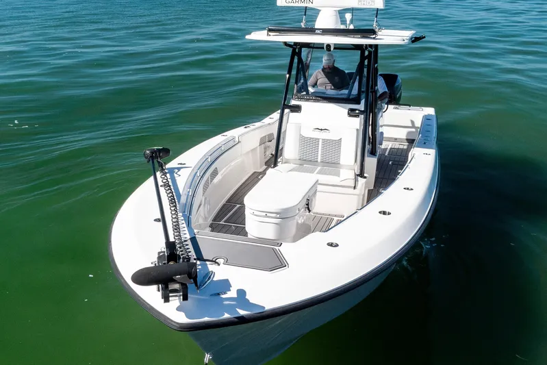  Yacht Photos Pics 2022 Invincible 33 Open Fisherman boat on calm water, featuring advanced navigation equipment.