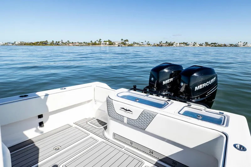  Yacht Photos Pics 2022 Invincible 33 Open Fisherman boat with twin Mercury engines on calm water.