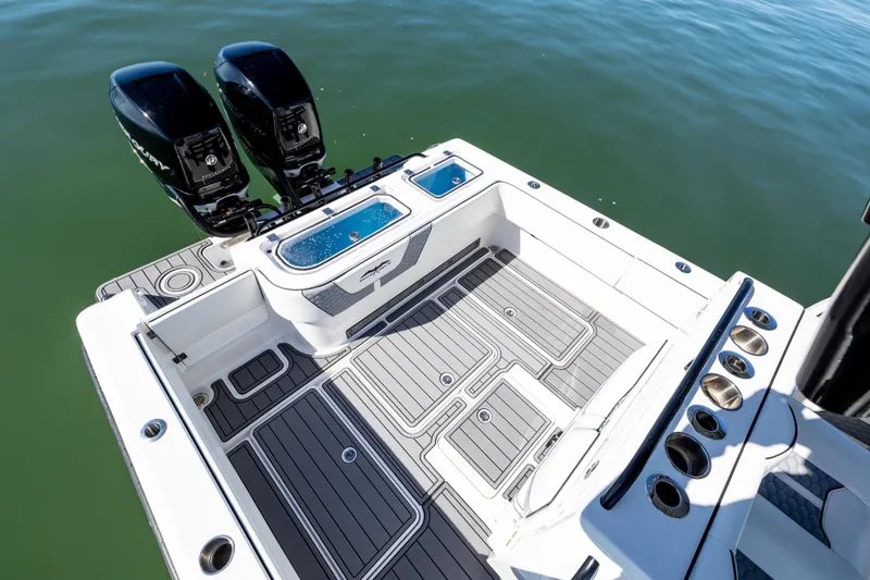  Yacht Photos Pics 2022 Invincible 33 Open Fisherman boat deck with twin engines on calm water.