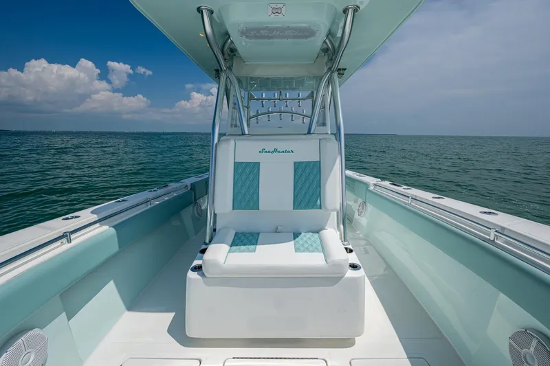 Yacht Photos Pics 2023 SeaHunter 31 Tournament boat interior with cushioned seating, ocean view, and clear blue sky.