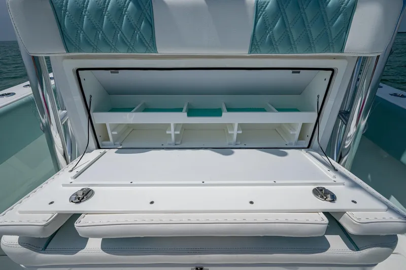  Yacht Photos Pics 2023 SeaHunter 31 Tournament boat storage compartment with cushioned seating and organized interior.