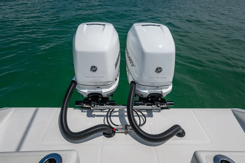  Yacht Photos Pics Twin Mercury outboard engines on 2023 SeaHunter 31 Tournament boat, floating on clear water.