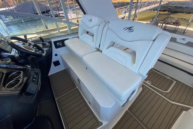  Yacht Photos Pics 2017 Monterey 355 Sport Yacht interior with white seating and steering wheel.