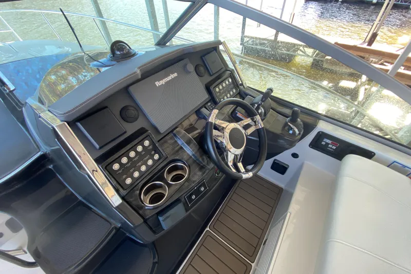  Yacht Photos Pics Cockpit of 2017 Monterey 355 Sport Yacht with steering wheel and control panel.