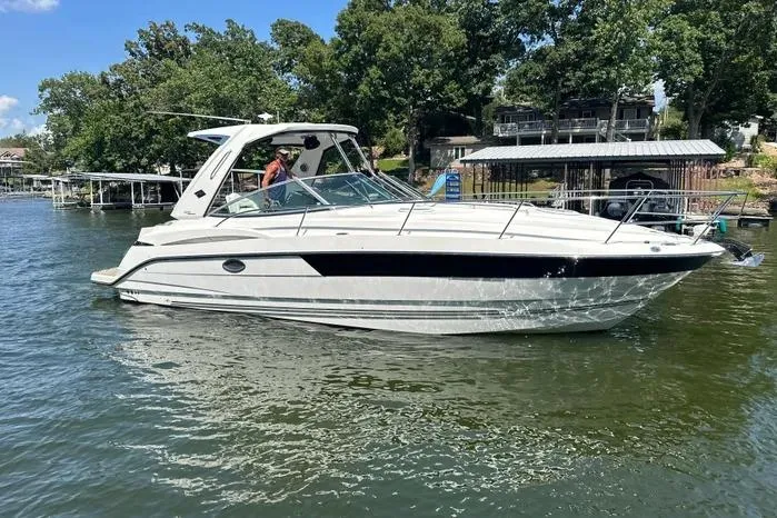 Yacht Photos Pics 2017 Monterey 355 Sport Yacht on a lake, surrounded by trees and docks.