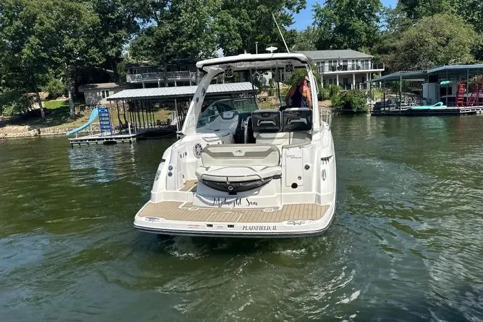  Yacht Photos Pics 2017 Monterey 355 Sport Yacht on a lake, surrounded by docks and trees.