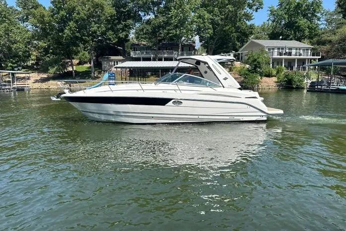  Yacht Photos Pics 2017 Monterey 355 Sport Yacht cruising on a serene lake with lush greenery.
