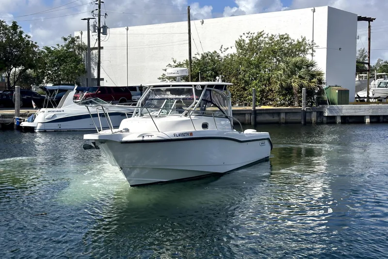  Yacht Photos Pics 2006 Boston Whaler 285 Conquest boat docked in a marina, clear sky background.