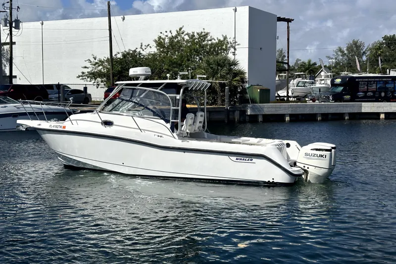  Yacht Photos Pics 2006 Boston Whaler 285 Conquest boat with Suzuki engine docked in marina.