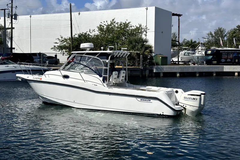  Yacht Photos Pics 2006 Boston Whaler 285 Conquest boat with Suzuki engine on calm water.
