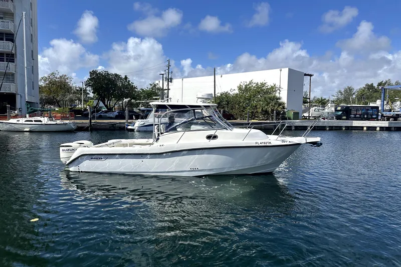  Yacht Photos Pics 2006 Boston Whaler 285 Conquest boat docked in a marina under a clear blue sky.