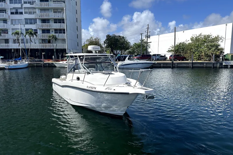  Yacht Photos Pics 2006 Boston Whaler 285 Conquest boat docked in a marina, clear sky background.