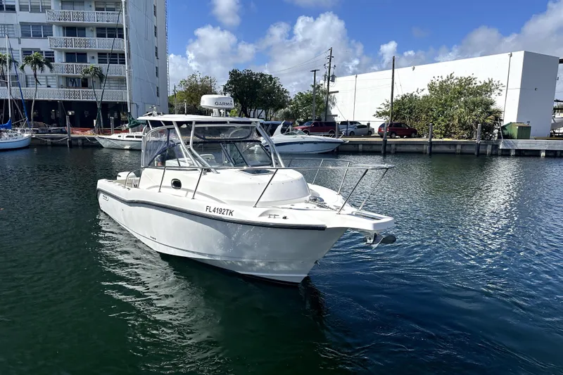  Yacht Photos Pics 2006 Boston Whaler 285 Conquest boat docked in marina, clear sky background.