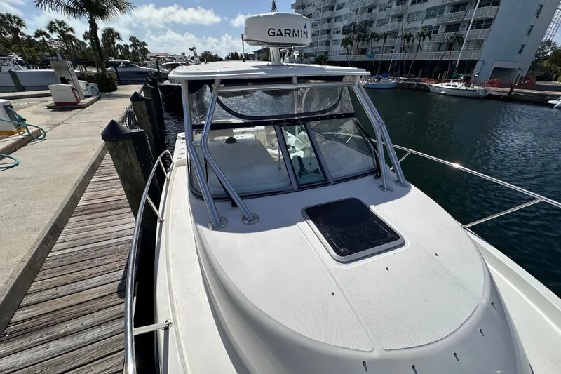  Yacht Photos Pics 2006 Boston Whaler 285 Conquest docked, featuring Garmin equipment, in a marina setting.