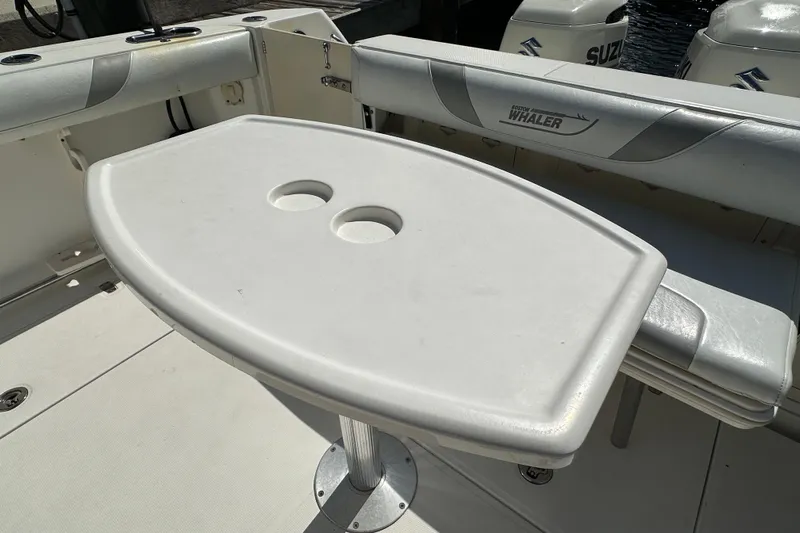  Yacht Photos Pics 2006 Boston Whaler 285 Conquest boat interior with table and seating.