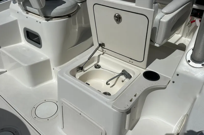  Yacht Photos Pics 2006 Boston Whaler 285 Conquest boat interior with open storage compartment and seating.