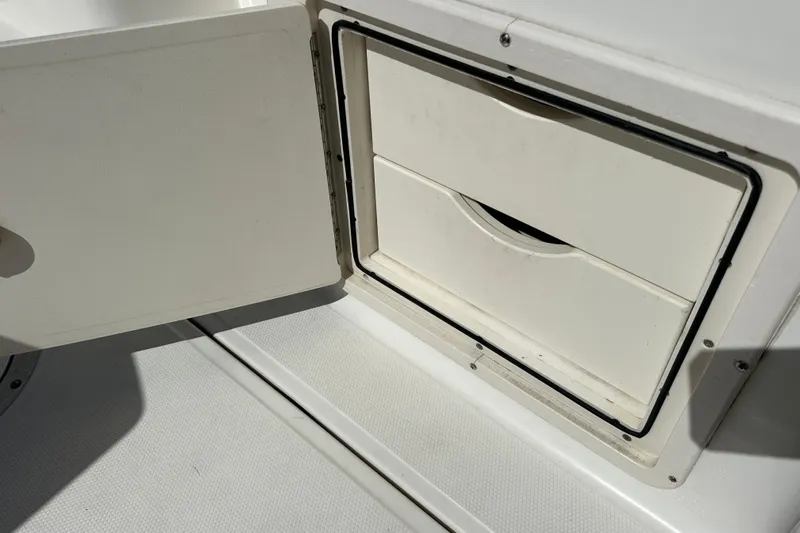  Yacht Photos Pics Storage compartment on a 2006 Boston Whaler 285 Conquest boat, open and empty.