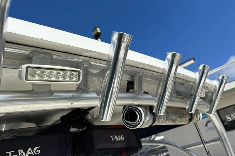  Yacht Photos Pics Boston Whaler 285 Conquest 2006 boat rod holders and LED lights under clear blue sky.