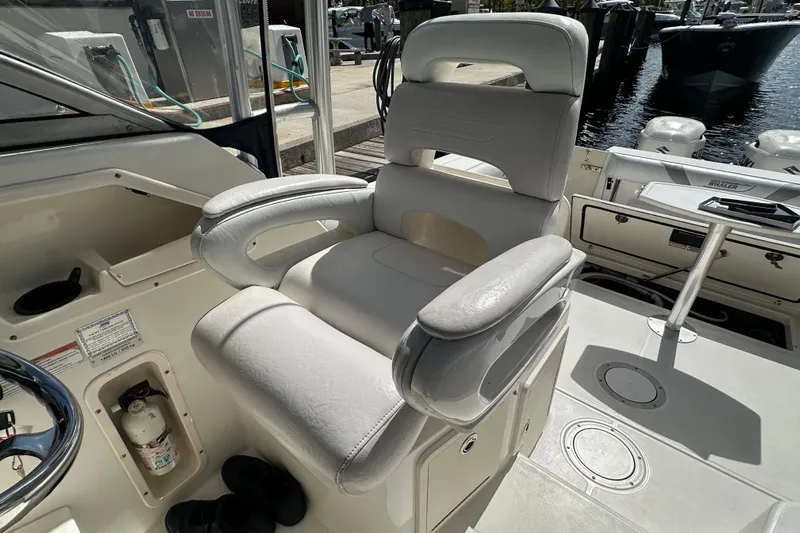  Yacht Photos Pics Captain's chair on 2006 Boston Whaler 285 Conquest boat, docked at marina.