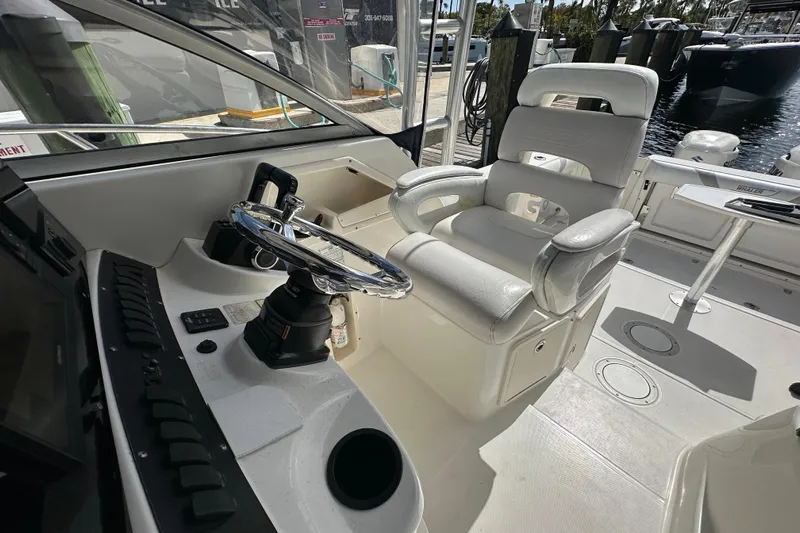  Yacht Photos Pics 2006 Boston Whaler 285 Conquest helm with steering wheel and captain's chair.