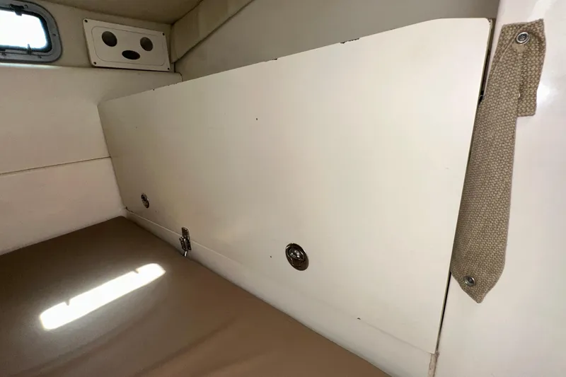  Yacht Photos Pics Interior cabin of 2006 Boston Whaler 285 Conquest boat, featuring storage compartment.