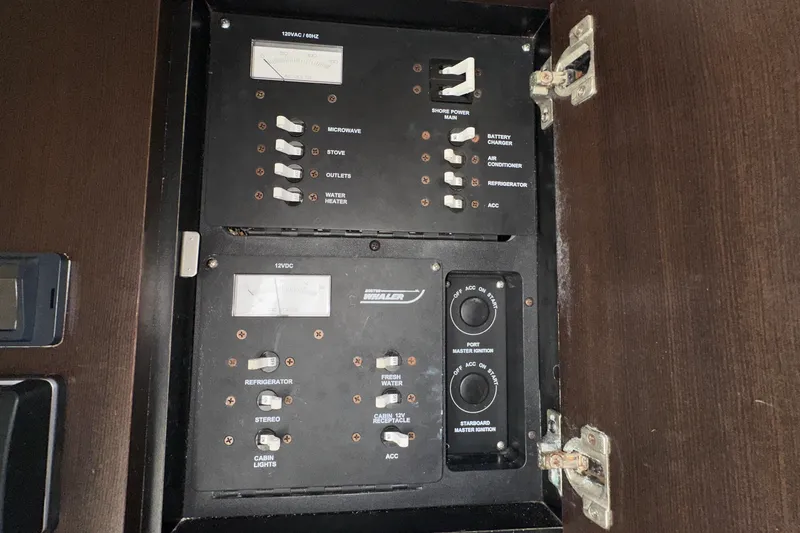  Yacht Photos Pics Electrical panel of a 2006 Boston Whaler 285 Conquest boat, showing switches and meters.