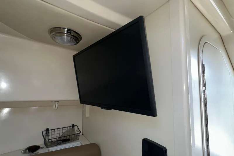  Yacht Photos Pics Interior of 2006 Boston Whaler 285 Conquest with mounted TV and storage basket.