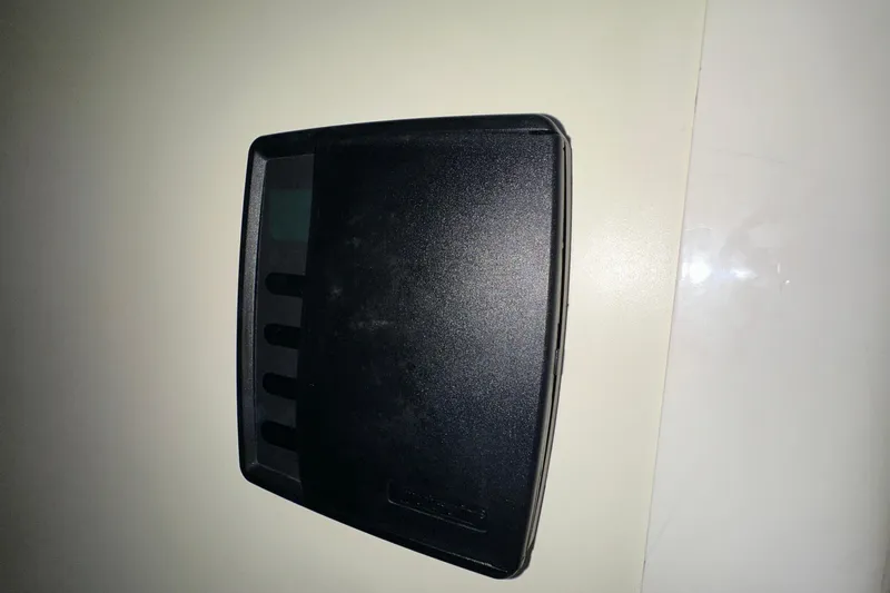  Yacht Photos Pics Black electronic device on a white surface, possibly a control panel or cover.