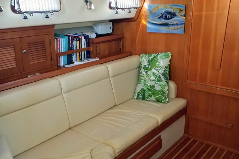 Open Agenda Yacht Photos Pics Interior of 2006 Island Packet 370 sailboat with beige seating and wooden cabinetry.