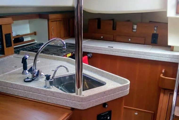 Open Agenda Yacht Photos Pics 2006 Island Packet 370 yacht interior with modern kitchen and wooden cabinetry.