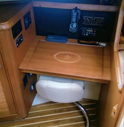 Open Agenda Yacht Photos Pics Navigation station in 2006 Island Packet 370 sailboat with wooden desk and communication equipment.