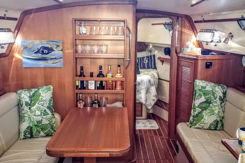 Open Agenda Yacht Photos Pics Cozy interior of 2006 Island Packet 370 sailboat with dining area and cabin.