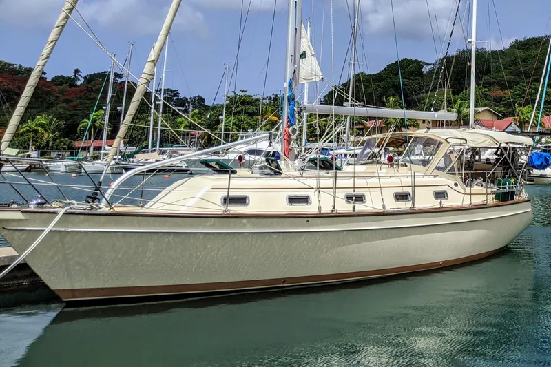 Open Agenda Yacht Photos Pics 2006 Island Packet 370 sailboat docked in a scenic marina setting.