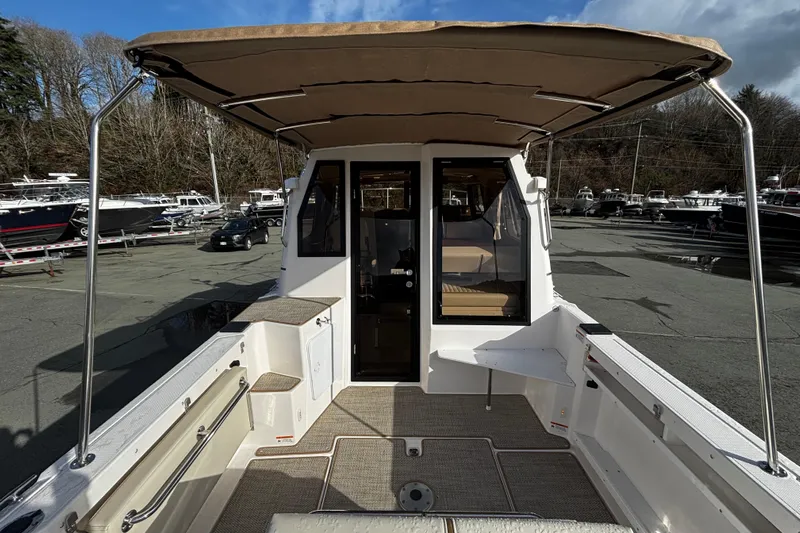  Yacht Photos Pics 2026 Ranger Tugs R-27 boat with canopy in harbor.