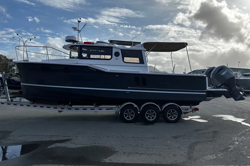  Yacht Photos Pics Ranger Tugs R-27 2026 on trailer under cloudy sky.